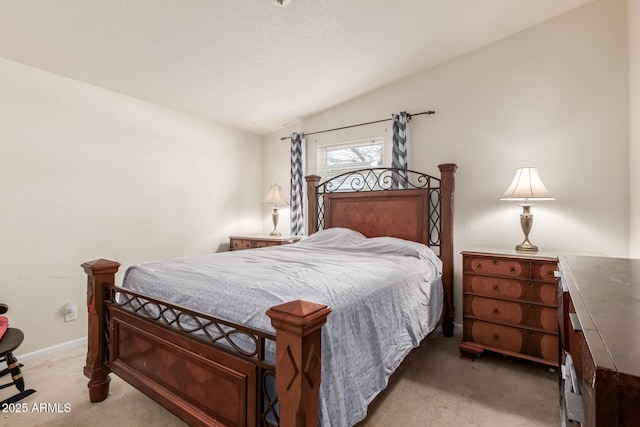 bedroom with vaulted ceiling and carpet flooring