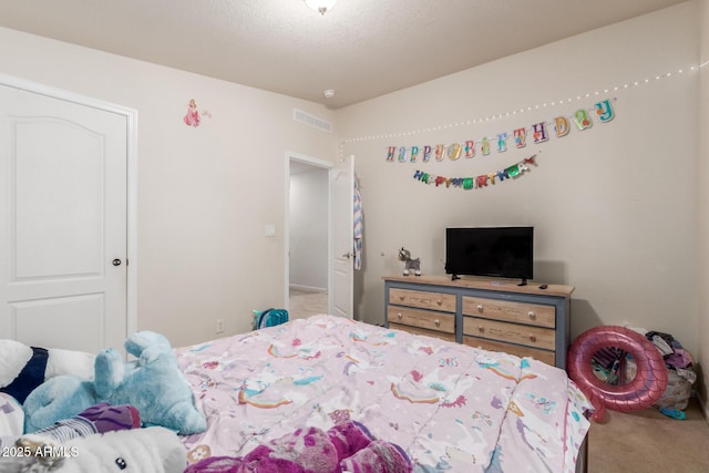 bedroom featuring carpet floors and a textured ceiling