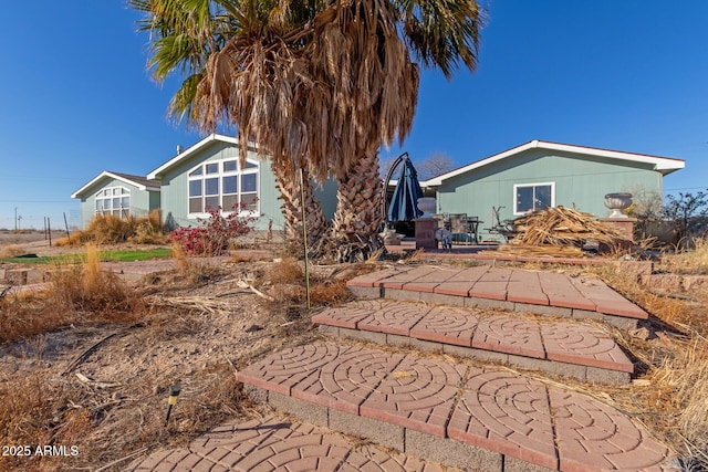 back of property featuring a patio