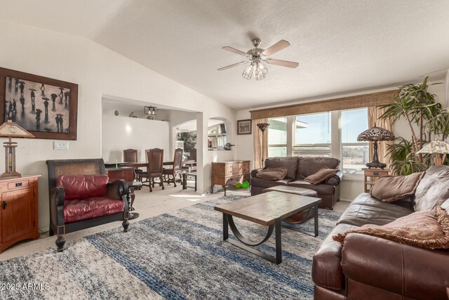 living room with ceiling fan, light colored carpet, a textured ceiling, and lofted ceiling