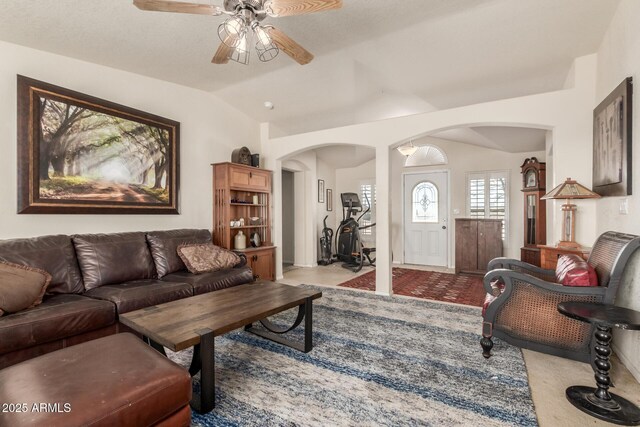 carpeted living room with ceiling fan and lofted ceiling