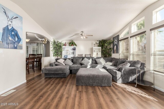 living room featuring ceiling fan, dark hardwood / wood-style floors, and lofted ceiling