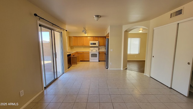 kitchen featuring stainless steel appliances and light tile patterned floors