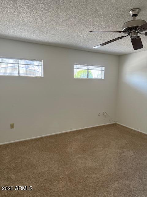 13822 N Silverbell Dr Unit 15C, Sun City, AZ 85351 - carpeted spare room with healthy amount of natural light, a ceiling fan, a textured ceiling, and baseboards