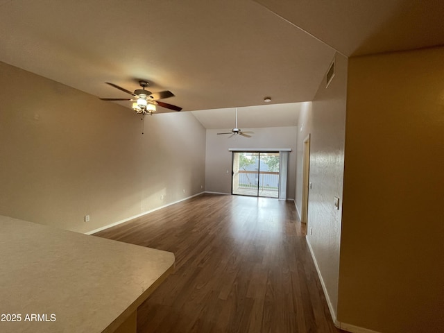 unfurnished living room with ceiling fan and dark hardwood / wood-style flooring