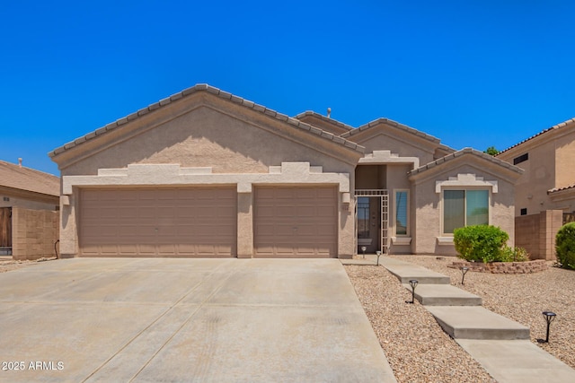 9142 W Pontiac Dr, Peoria, AZ 85382 - view of front of home with driveway, a garage, and stucco siding