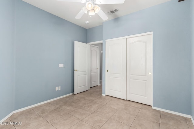 9142 W Pontiac Dr, Peoria, AZ 85382 - unfurnished bedroom featuring a closet, light tile patterned floors, and ceiling fan