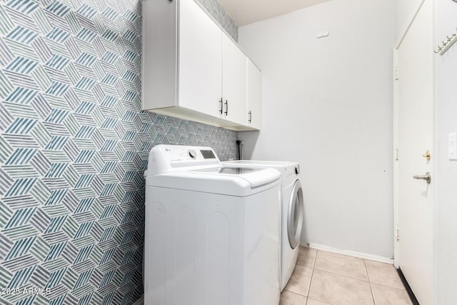 9142 W Pontiac Dr, Peoria, AZ 85382 - washroom featuring cabinet space, washer and clothes dryer, and light tile patterned flooring