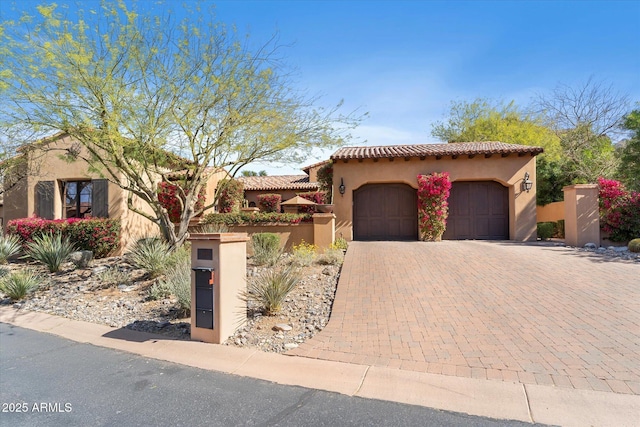 18683 N 101st Pl, Scottsdale, AZ 85255 - mediterranean / spanish home featuring a garage, a tile roof, fence, decorative driveway, and stucco siding