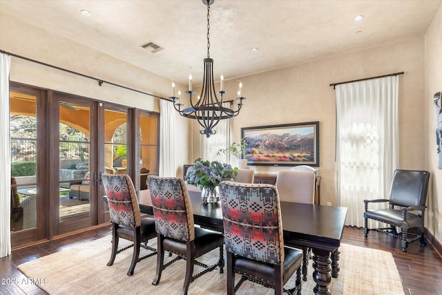 dining room featuring a notable chandelier, visible vents, baseboards, french doors, and wood-type flooring