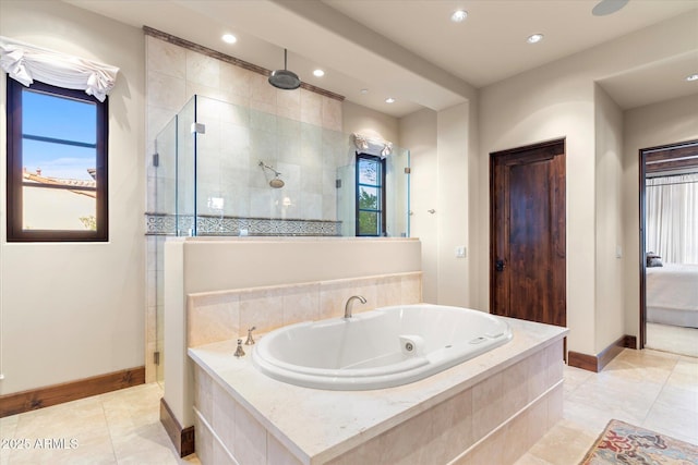 bathroom featuring a whirlpool tub, baseboards, tiled shower, and tile patterned floors