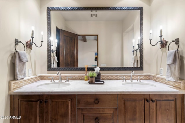 full bathroom with double vanity, visible vents, and a sink