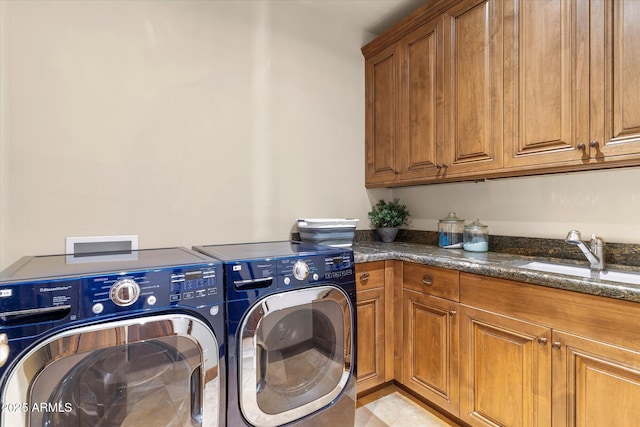 washroom featuring washer and clothes dryer, a sink, and cabinet space