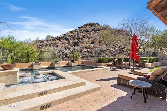 view of patio / terrace with fence and a jacuzzi