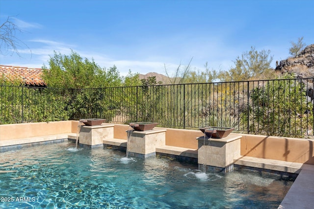 view of pool featuring fence