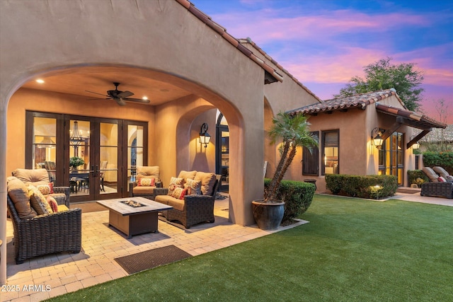 view of patio featuring french doors, an outdoor living space with a fire pit, and ceiling fan