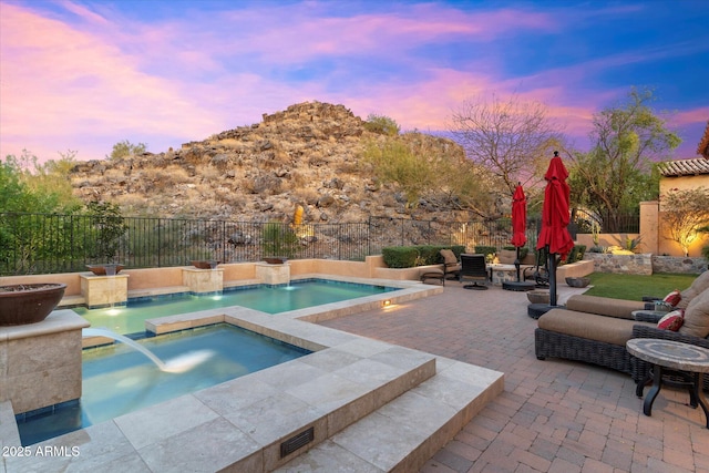 view of pool featuring a patio, a fenced backyard, and a jacuzzi