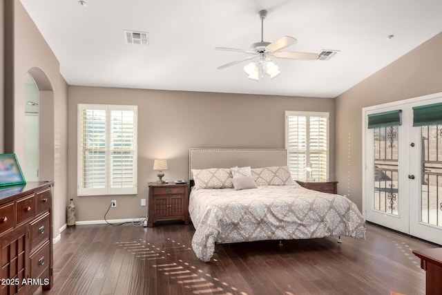 bedroom featuring ceiling fan, access to exterior, lofted ceiling, and dark wood-type flooring