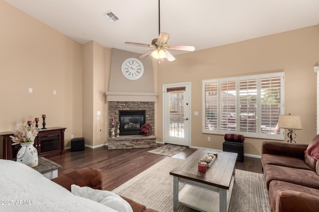 living room featuring a fireplace, dark hardwood / wood-style floors, and ceiling fan