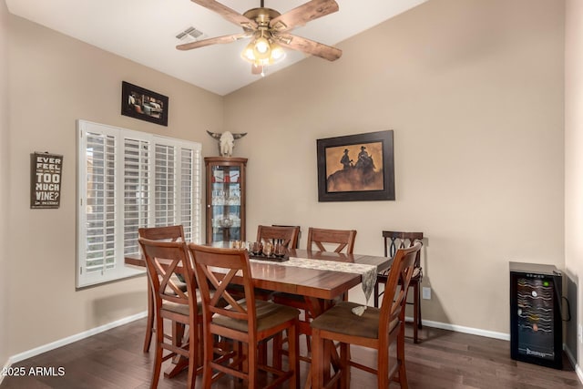 dining room with wine cooler, ceiling fan, and dark hardwood / wood-style floors