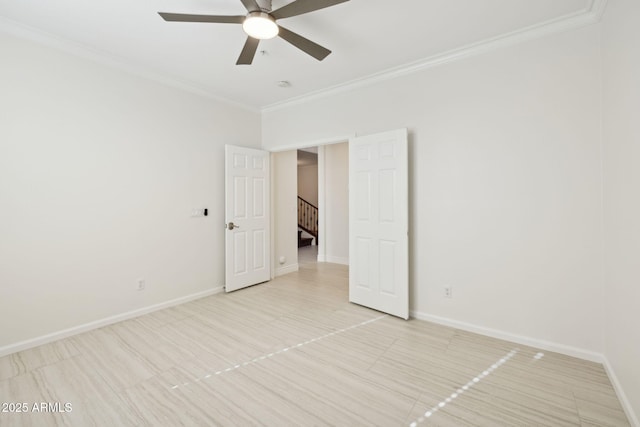 empty room with ornamental molding and ceiling fan