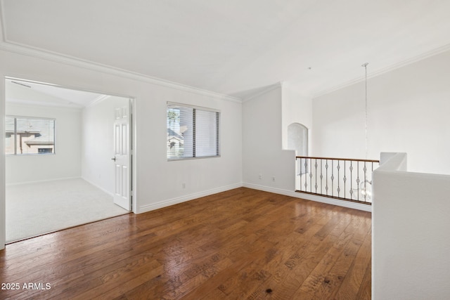 unfurnished room featuring wood-type flooring, ornamental molding, and a wealth of natural light