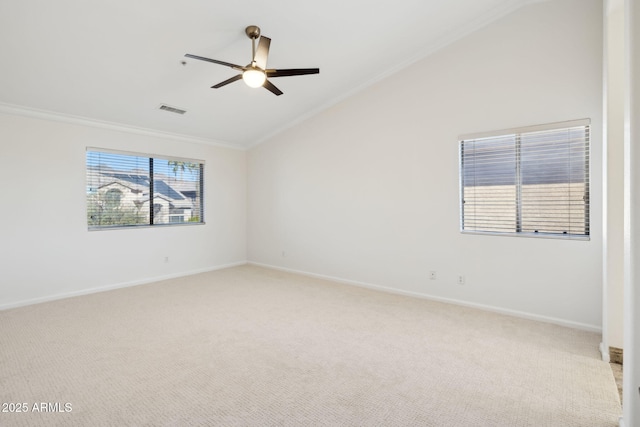 carpeted empty room with crown molding, vaulted ceiling, and ceiling fan