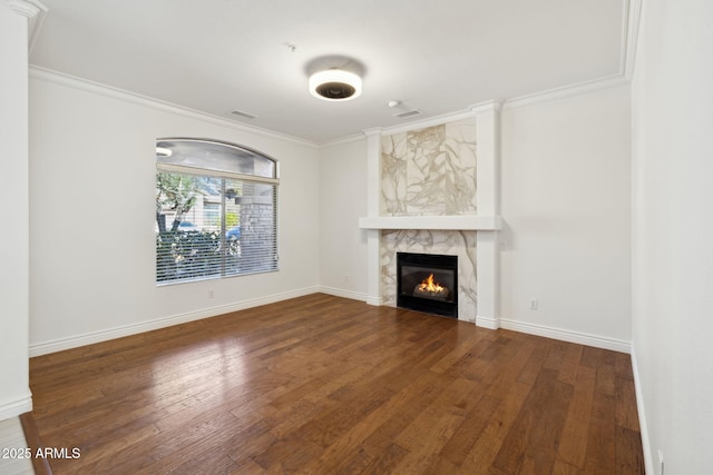 unfurnished living room with a fireplace, dark wood-type flooring, and ornamental molding