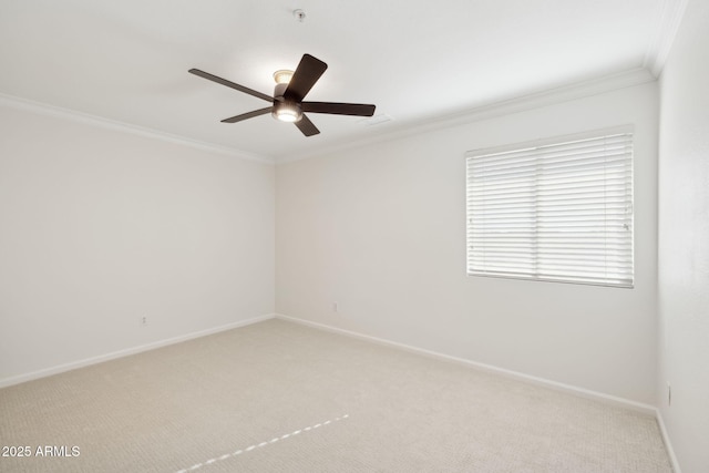 carpeted spare room with ornamental molding and ceiling fan