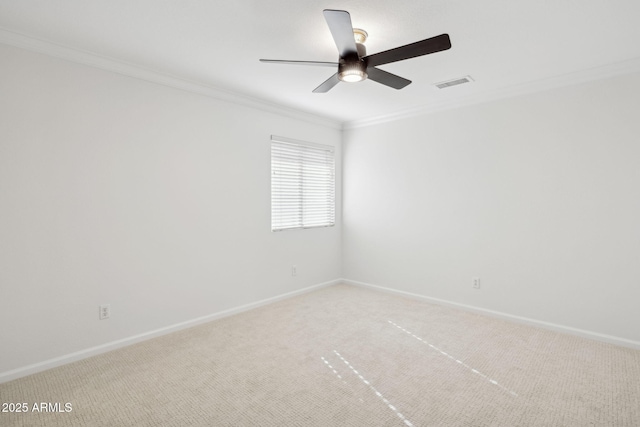 carpeted empty room featuring crown molding and ceiling fan