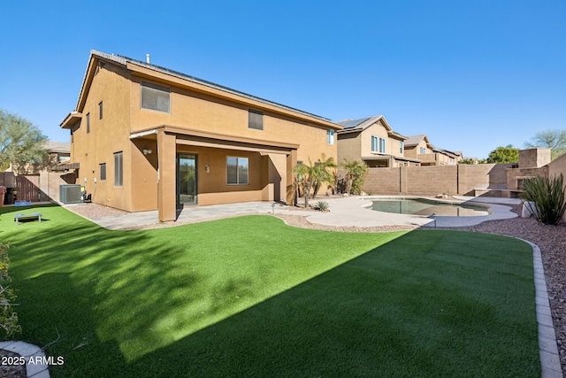 back of property featuring a fenced in pool, a yard, a patio area, and central air condition unit