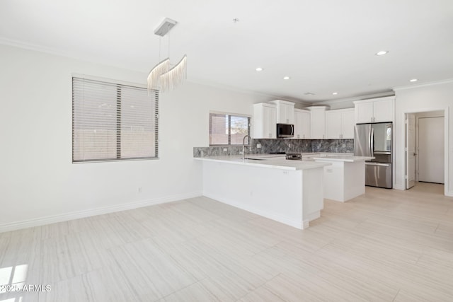 kitchen with appliances with stainless steel finishes, a breakfast bar, white cabinetry, backsplash, and hanging light fixtures