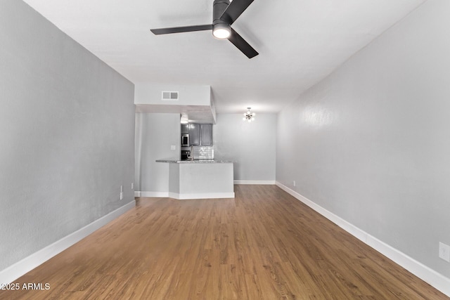 3416 N 44th St Unit 70, Phoenix, AZ 85018 - unfurnished living room with a ceiling fan, wood finished floors, and baseboards