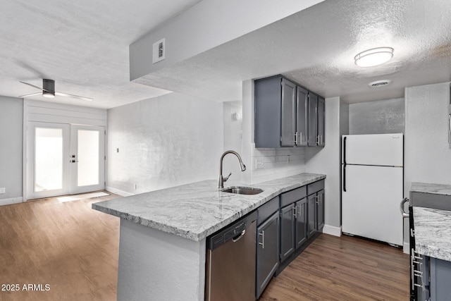 3416 N 44th St Unit 70, Phoenix, AZ 85018 - kitchen with freestanding refrigerator, dishwasher, a sink, a peninsula, and dark wood-style flooring