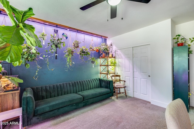 sitting room featuring ceiling fan and carpet flooring