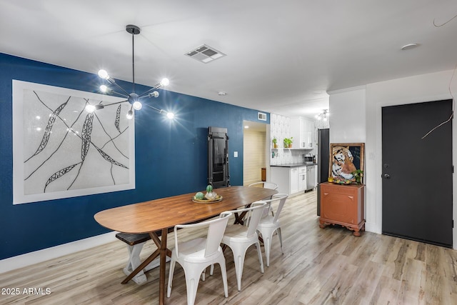 dining area with baseboards, visible vents, and light wood-style floors