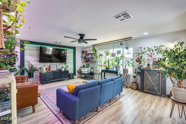 living area featuring ceiling fan, visible vents, wood finished floors, and recessed lighting