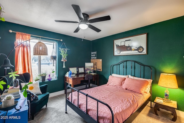 bedroom with ceiling fan, baseboards, and carpet flooring