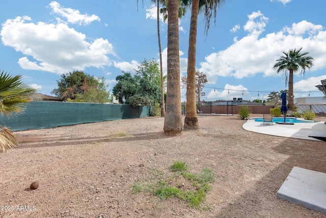 view of yard with a patio area, a fenced backyard, and a fenced in pool