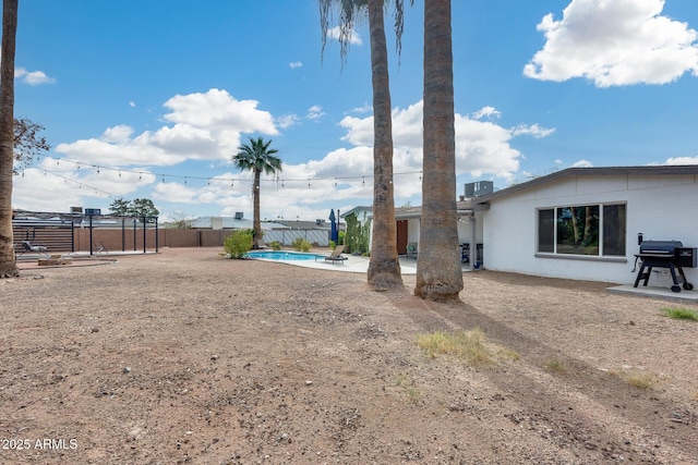 view of yard with a fenced backyard, a fenced in pool, and a patio