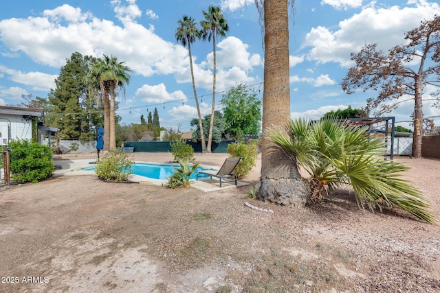 view of swimming pool featuring fence, a fenced in pool, and a patio