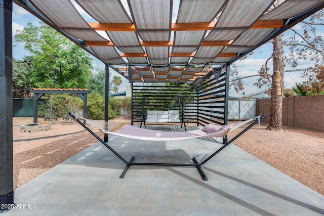 view of patio featuring fence and a pergola