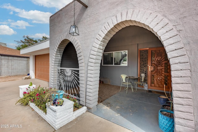 doorway to property with a garage and driveway