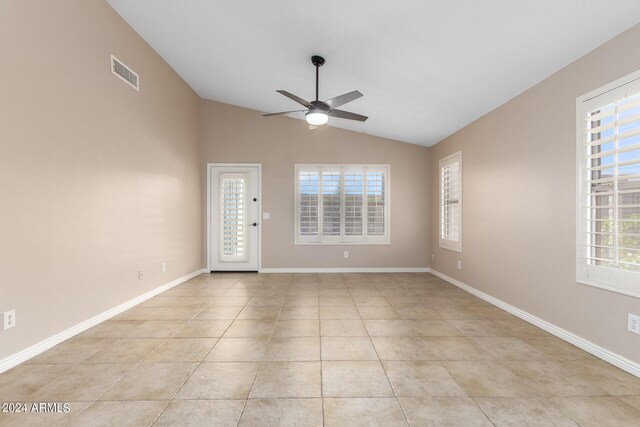 tiled spare room featuring ceiling fan and vaulted ceiling