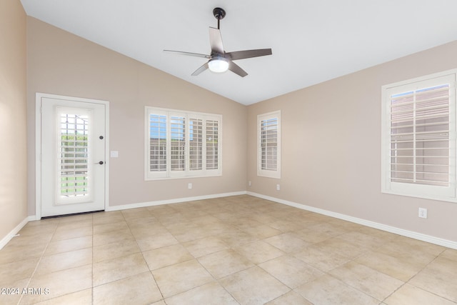 tiled empty room featuring ceiling fan and lofted ceiling