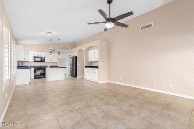 unfurnished living room featuring ceiling fan, light tile patterned flooring, sink, and high vaulted ceiling