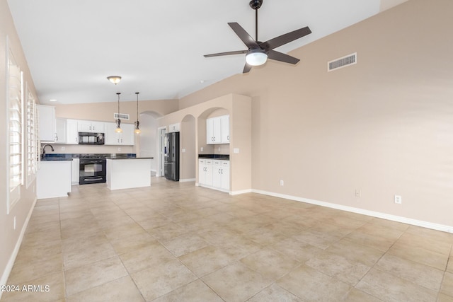 unfurnished living room with lofted ceiling, sink, and ceiling fan