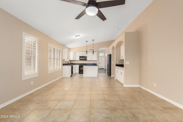 kitchen featuring vaulted ceiling, white cabinetry, sink, hanging light fixtures, and black appliances