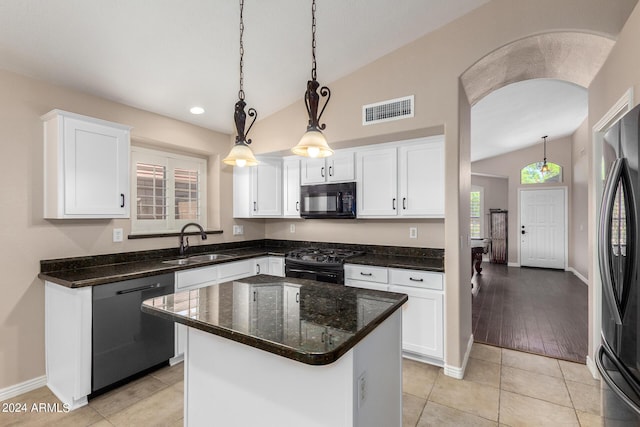 kitchen with decorative light fixtures, white cabinetry, sink, a center island, and black appliances