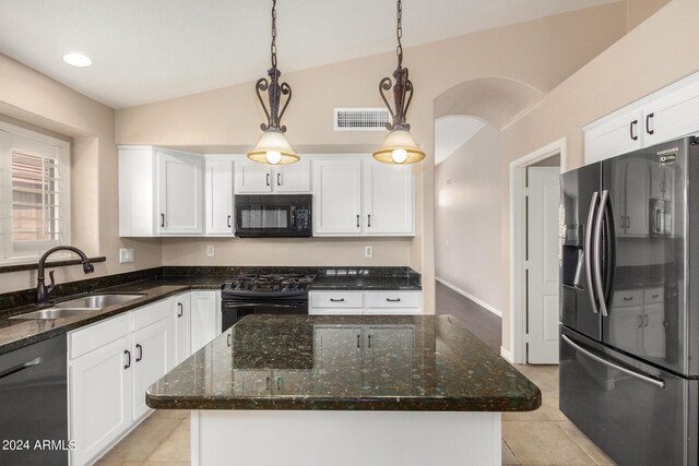 kitchen with a center island, vaulted ceiling, sink, black appliances, and decorative light fixtures